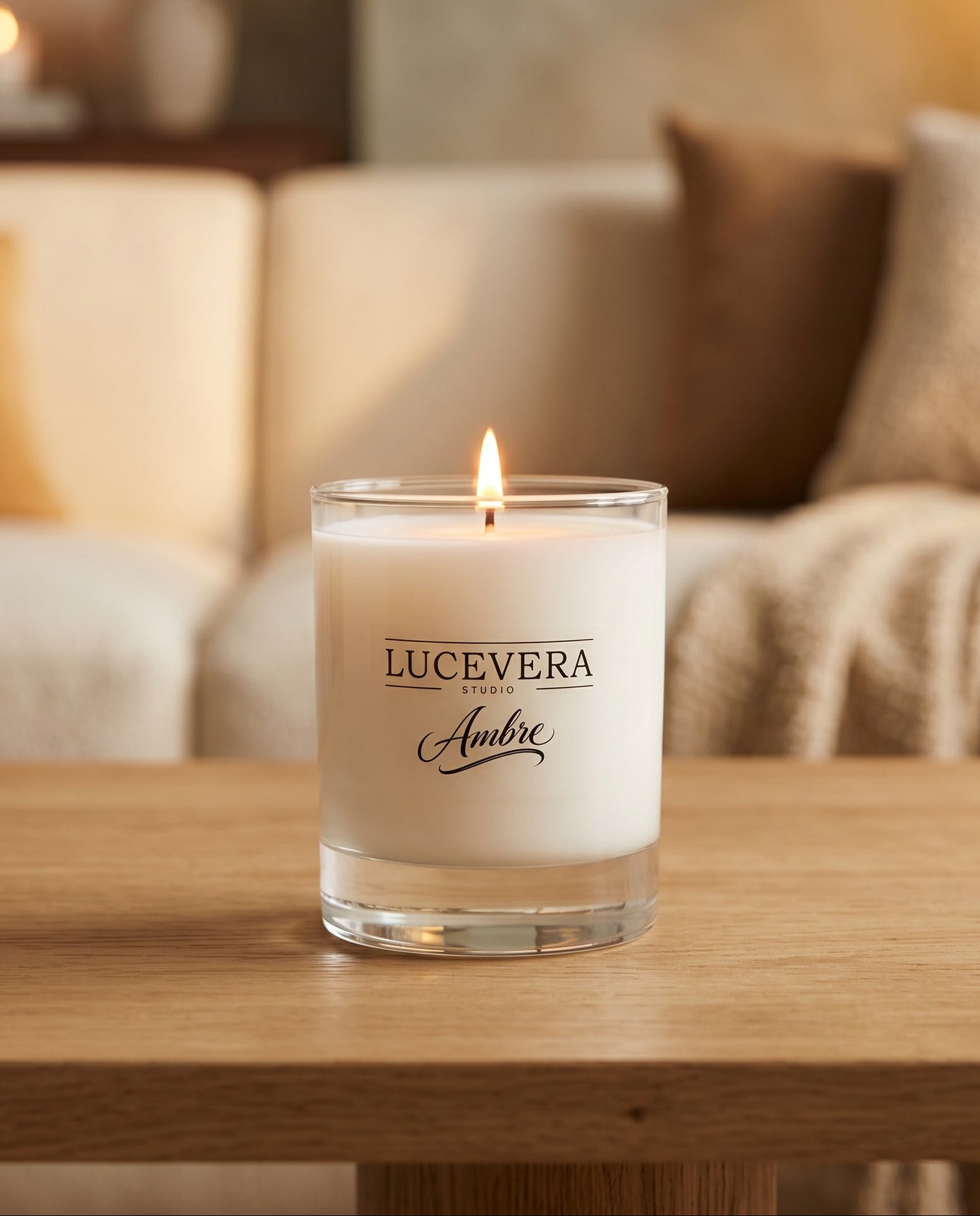 Lucevera Ambre candle on a wooden table with a blurred living room background