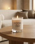 Lucevera candle on a wooden table with a blurred sofa in the background