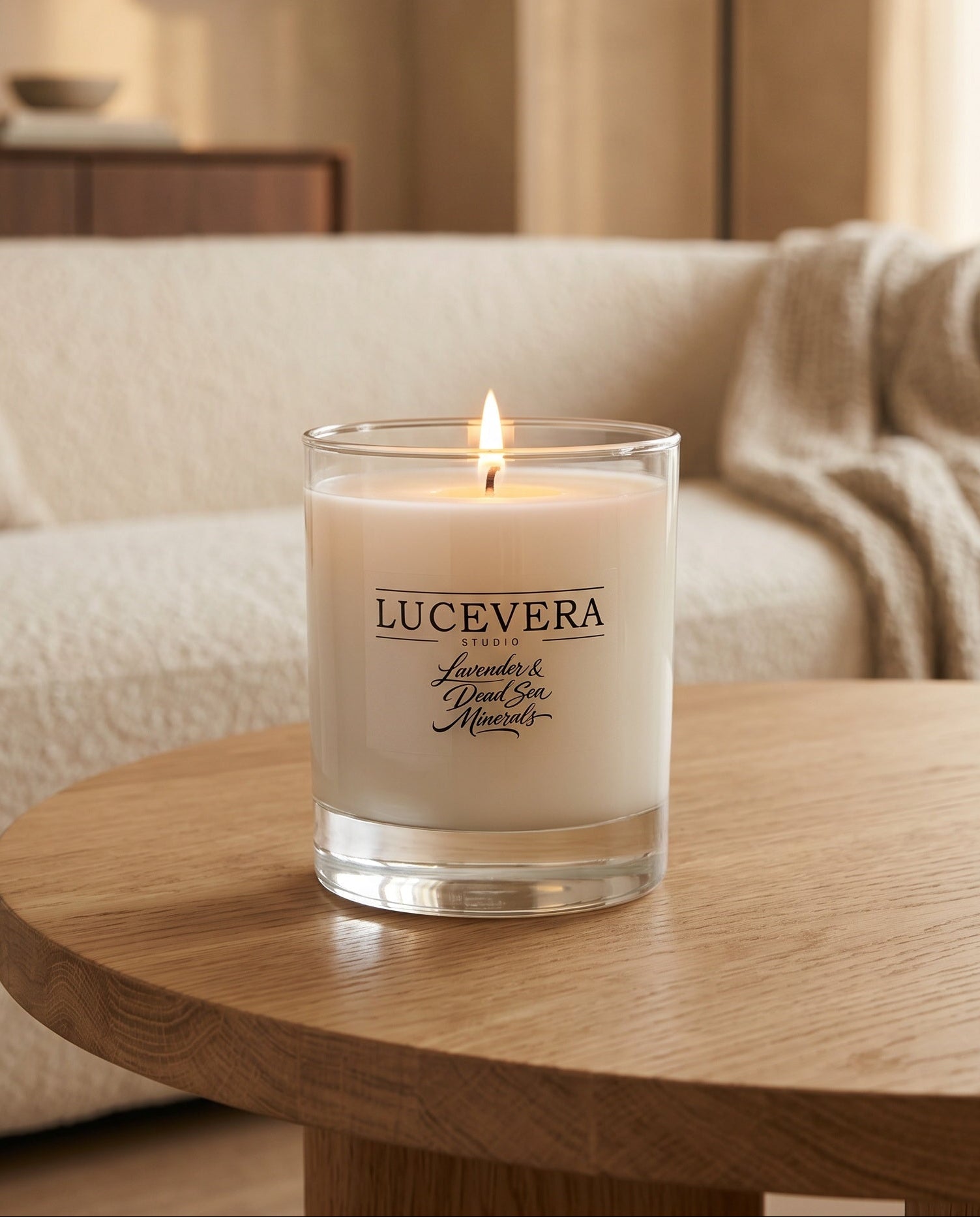 Lucevera candle on a wooden table with a blurred living room background