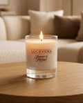Lucevera candle on a wooden table with a blurred living room background